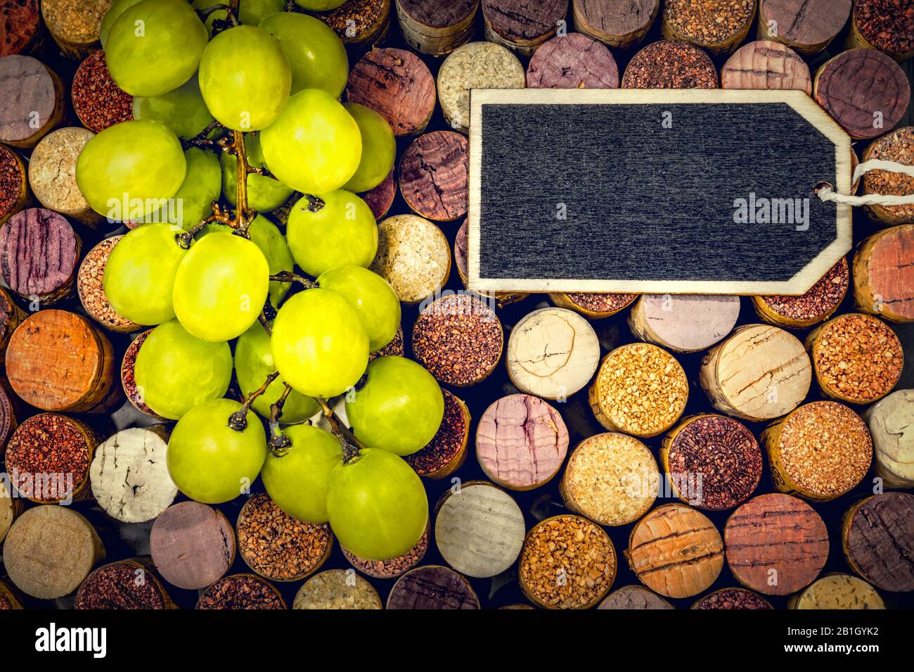 Full  frame with wine corks, graps  and a blackboard for individual text Stock Photo
