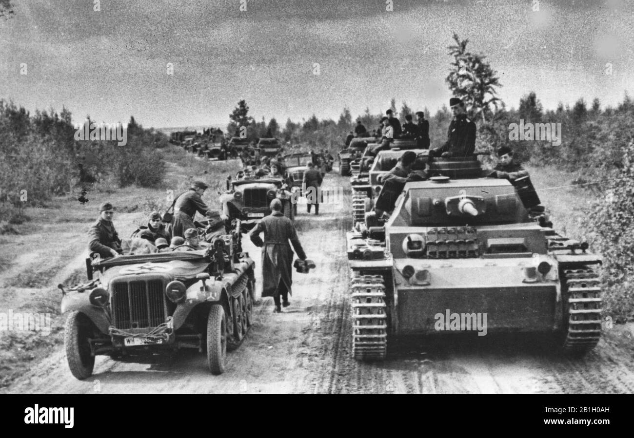 A column of German armored troops, including PzKpfw III Ausf G tanks, on a forest road on the Moscow front. October 1941 Stock Photo