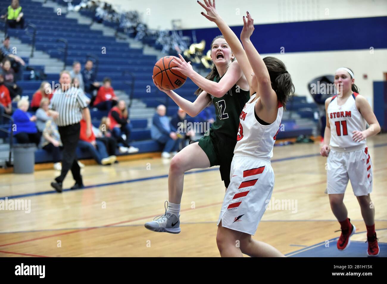 Player driving through the paint in an effort to score. USA. Stock Photo