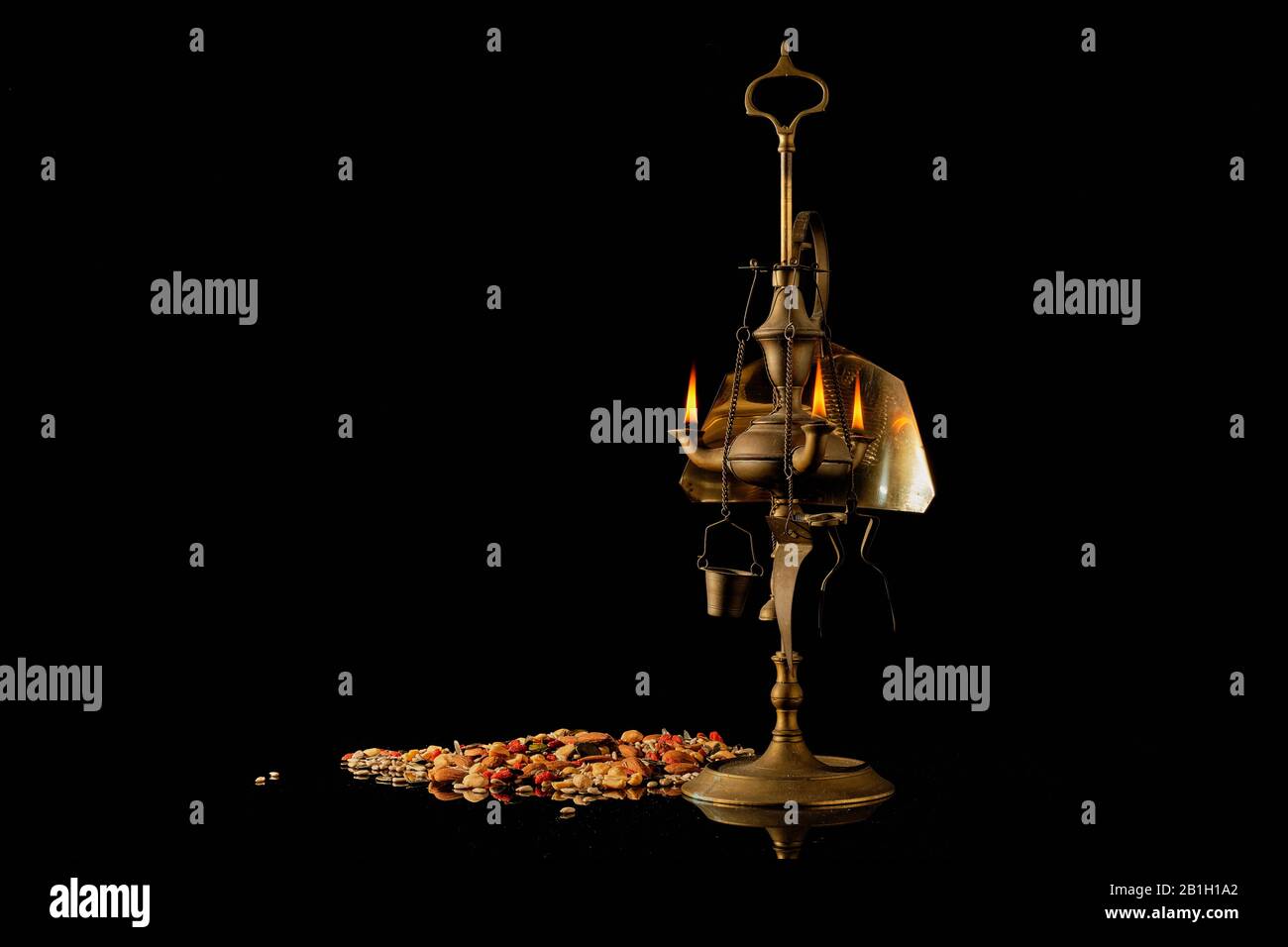 antique lamp moroccan oil lamp with seeds and book Stock Photo