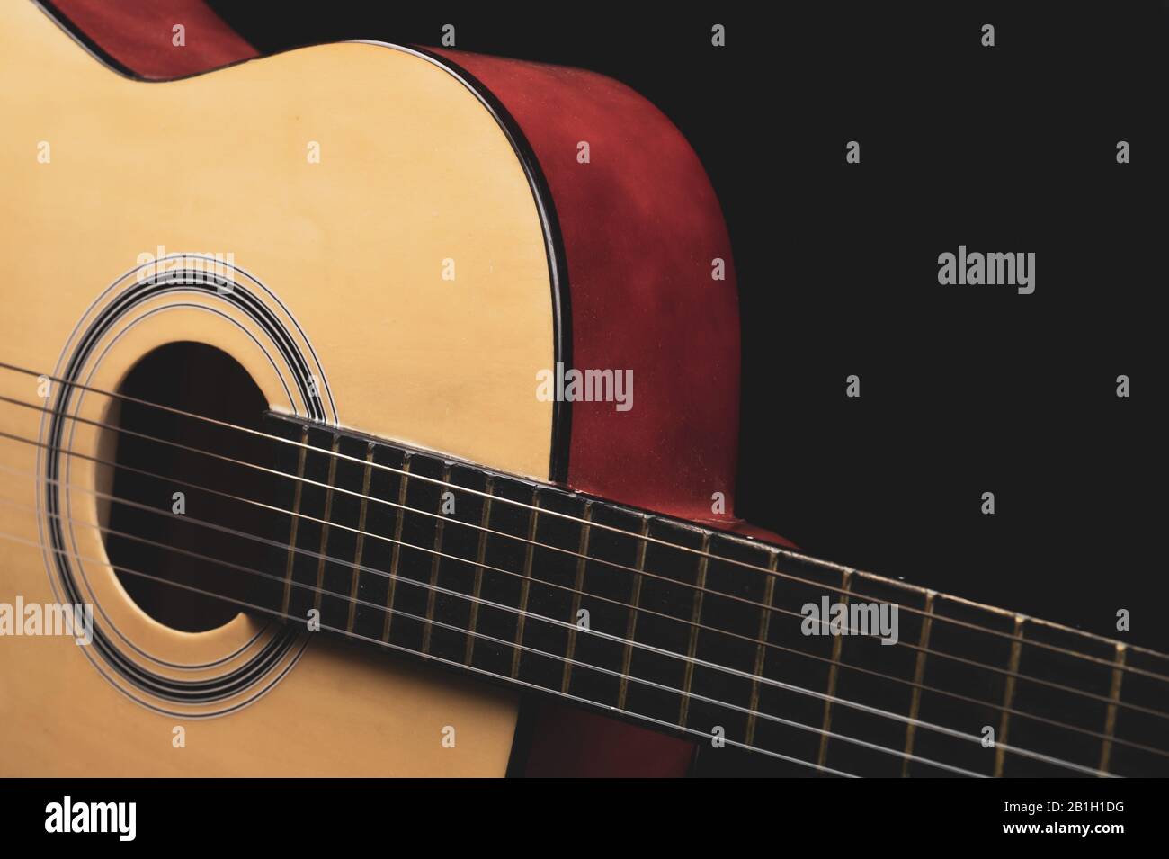 Guitar on the black background. acoustic musical instrument Stock Photo