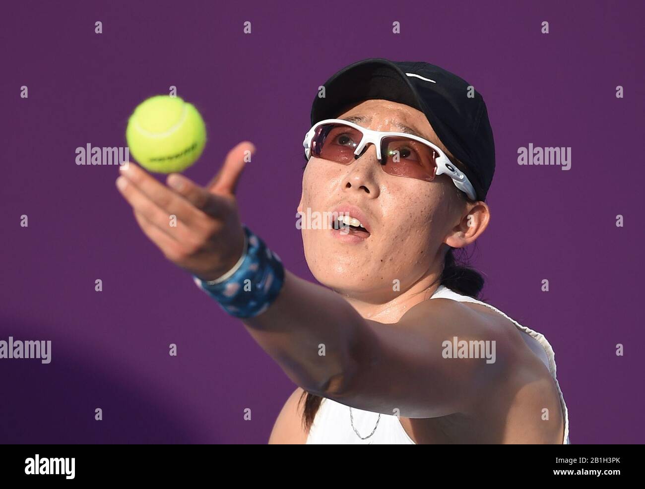 Doha, Qatar. 25th Feb, 2020. Zheng Saisai of China serves during the women's singles second round match against Vera Zvonareva of Russia at the 2020 WTA Qatar Open in Doha, Qatar, Feb. 25, 2020. Credit: Nikku/Xinhua/Alamy Live News Stock Photo