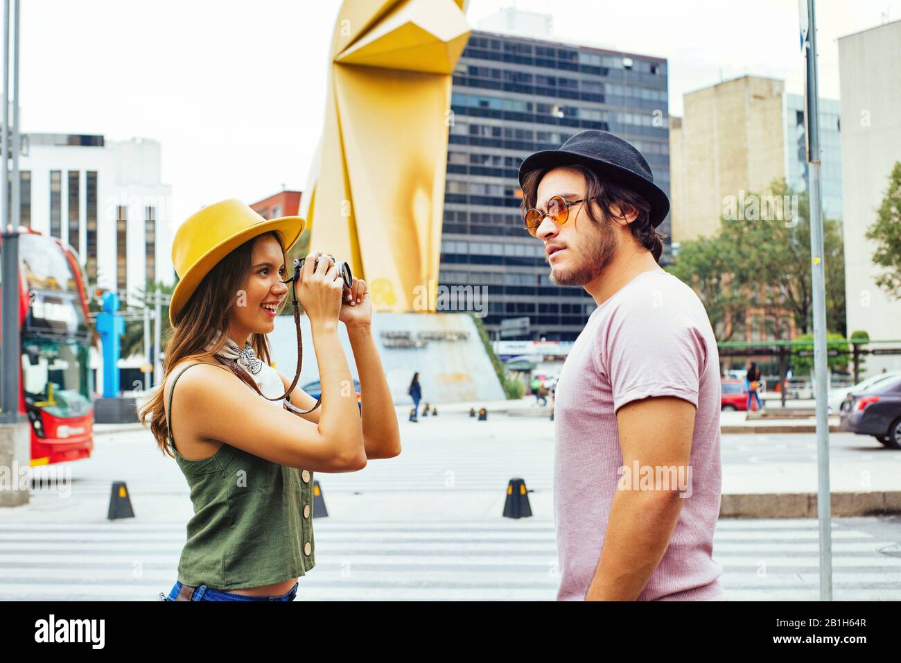 Portrait of a young couple traveling and taking a photo on street of Mexico City center Stock Photo