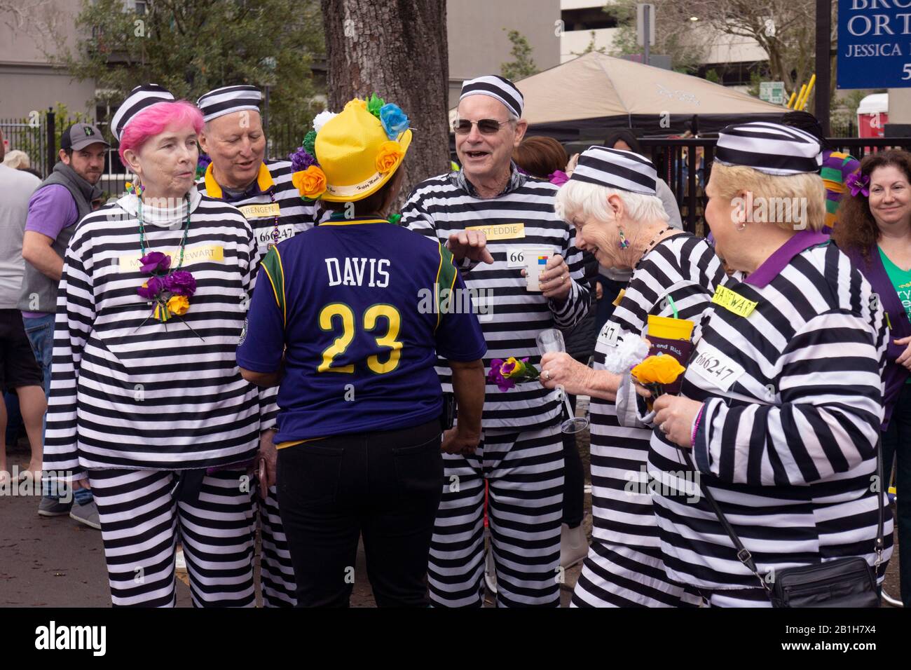 Group of friends costumed as prisoners on Mardi Gras day. New Orleans, LA, USA. Stock Photo
