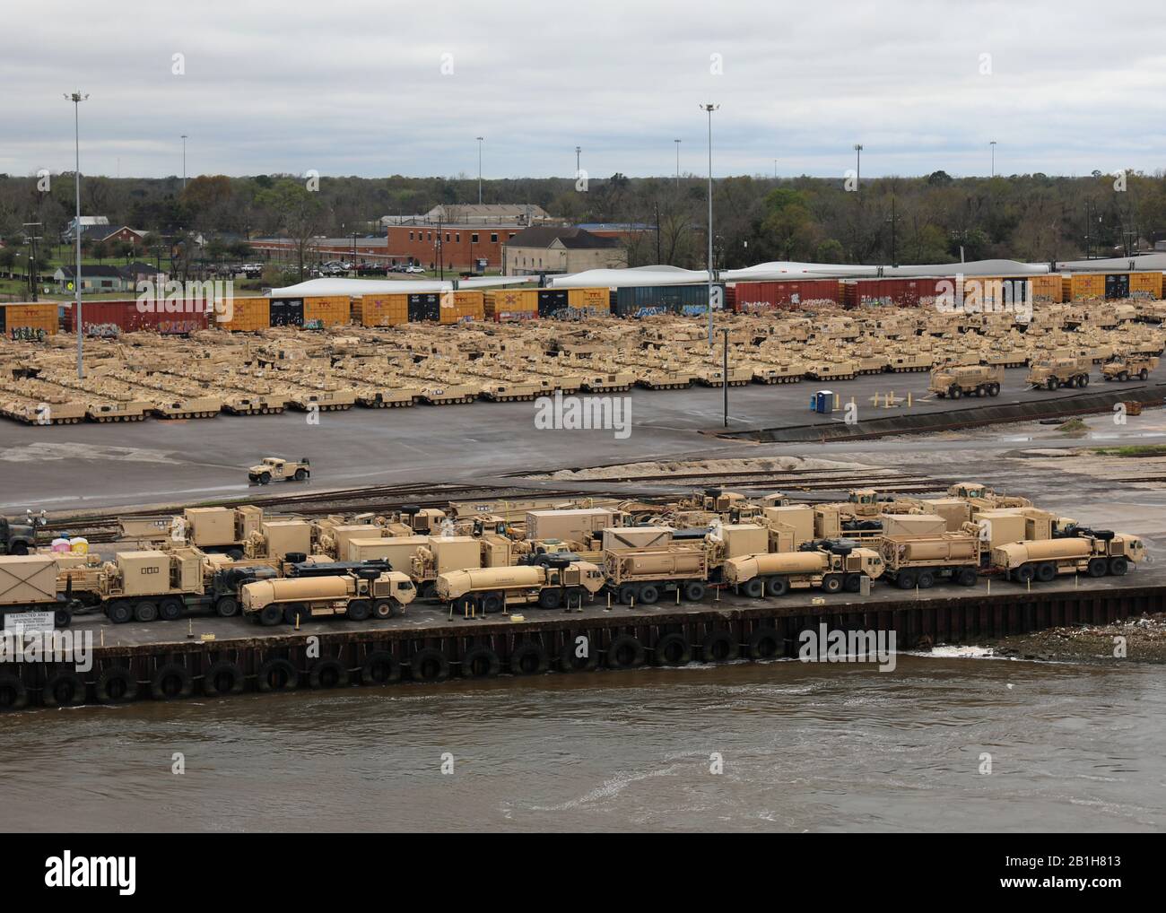 200220-N-OH262-0498 BEAUMONT, TX (February 20, 2020) A view of U.S. Army tanks, self-propelled artillery, armored personnel carriers and support vehicles staged for loading on to Military Sealift Command's large, medium-speed roll on/roll off ship USNS Benavidez (T-AKR 306), and the MSC chartered vehicle carrier MV Resolve, pier-side, at the Port of Beaumont, Texas, Feb. 20. The on-load of USNS Benavidez and MV Resolve was carried out in support of DEFENDER-Europe 2020. (U.S. Navy photo by Bill Mesta/released) Stock Photo