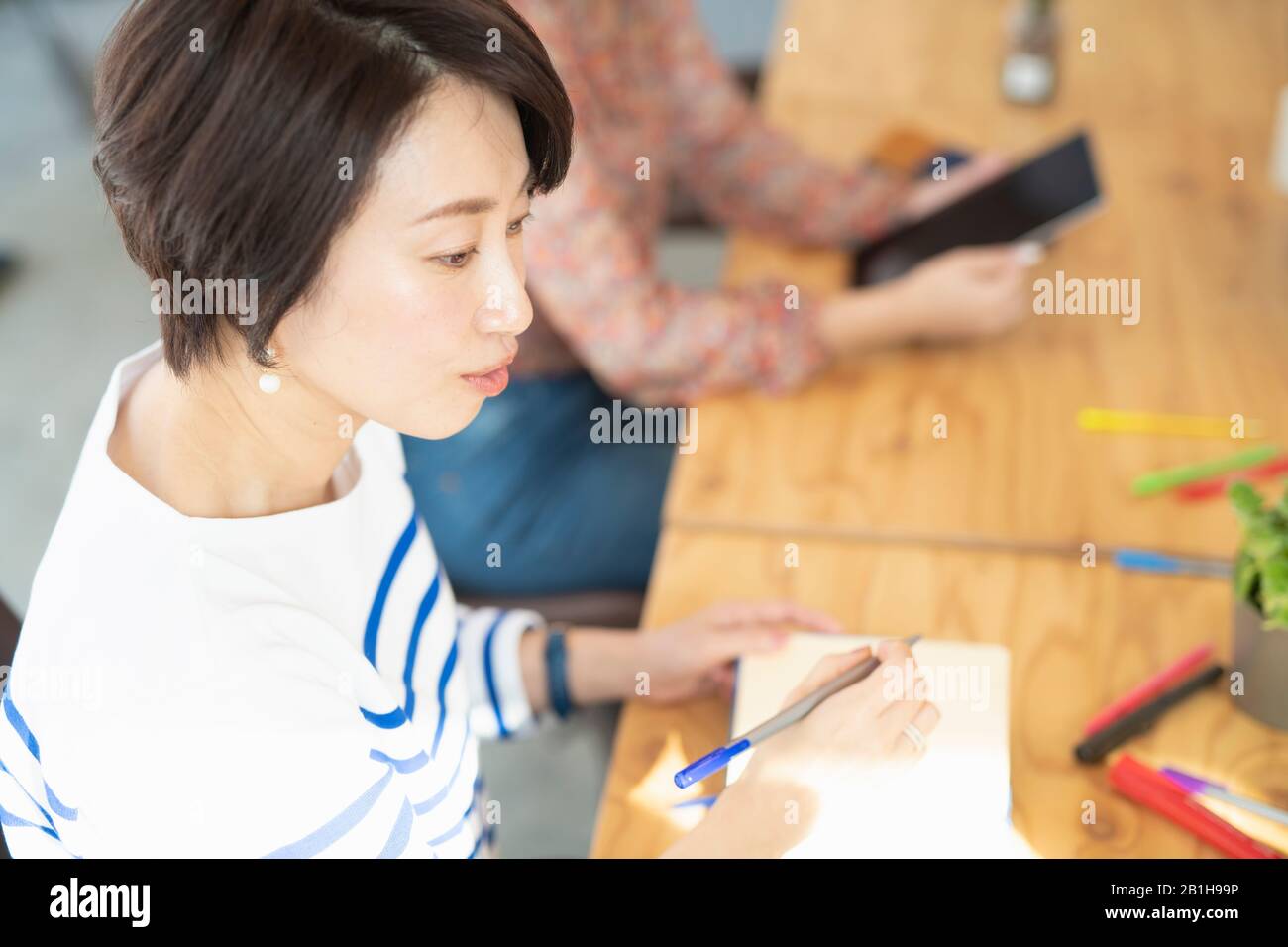 Mature woman thoughtful pen hi-res stock photography and images - Alamy