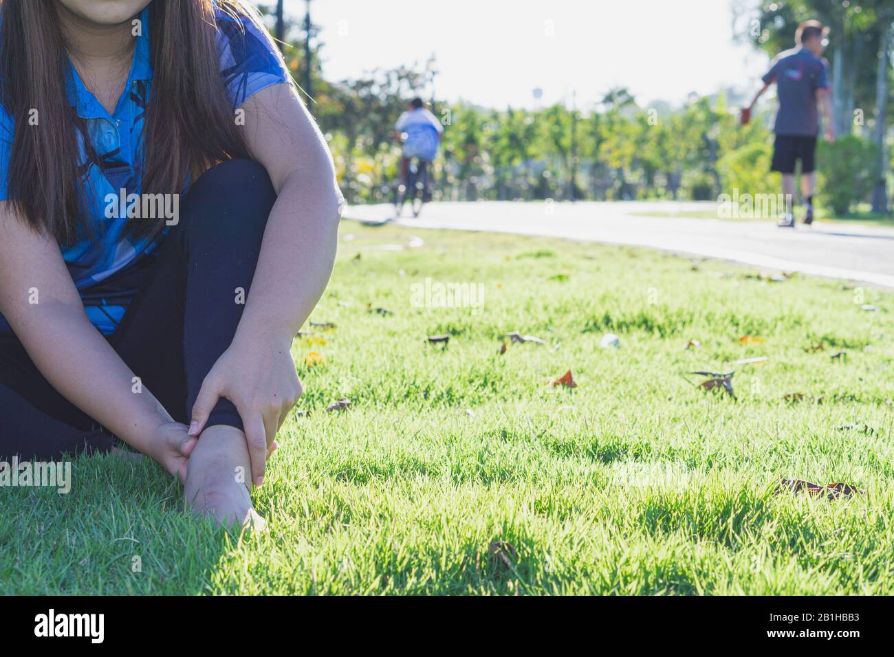 Ankle sprained. Young woman suffering from an ankle injury while