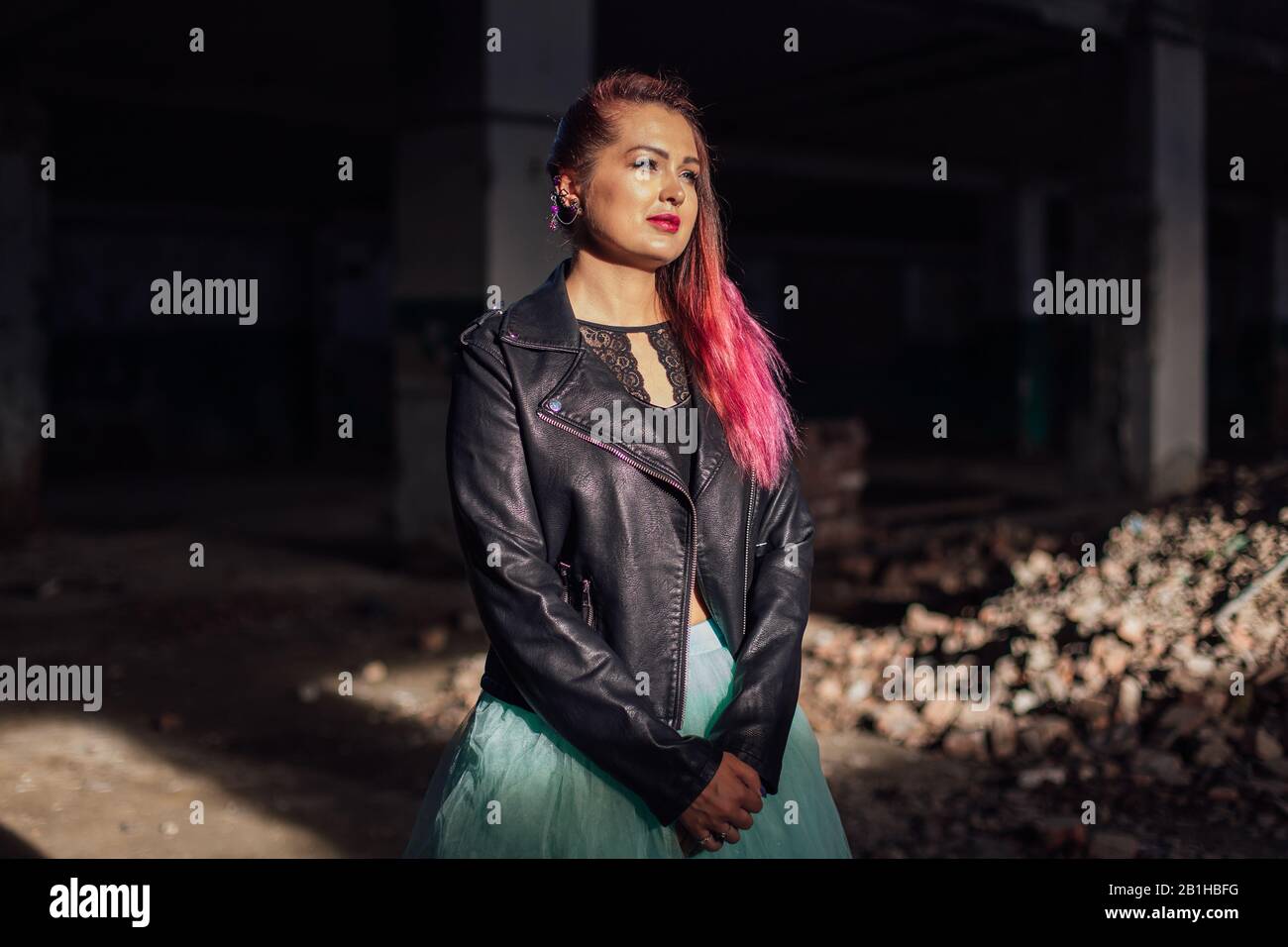 Pink Buildin Collapse Portrait of a young girl with pink hair standing next to the bricks in ...
