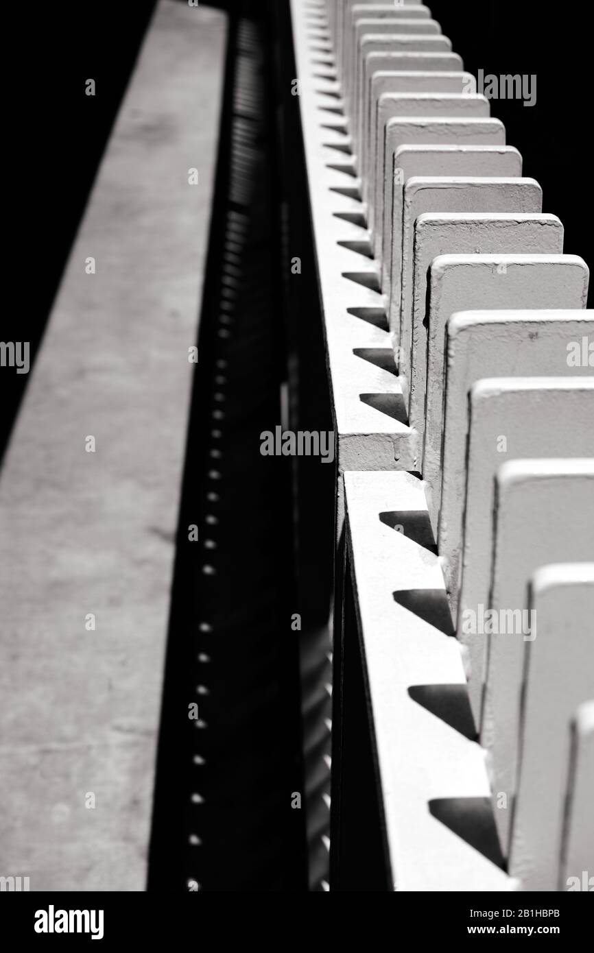 Vertical view of structural elements looking like dominoes lined up along pathway Stock Photo