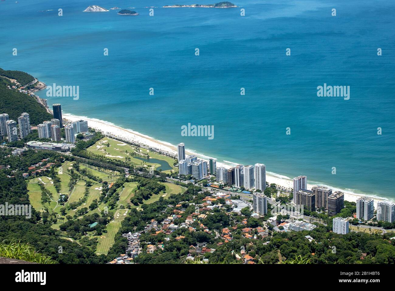 Top down view on the São Conrado neighbourhood with high rise buildings and beach in Rio de Janeiro, Brazil, with the green of the local golf club Stock Photo