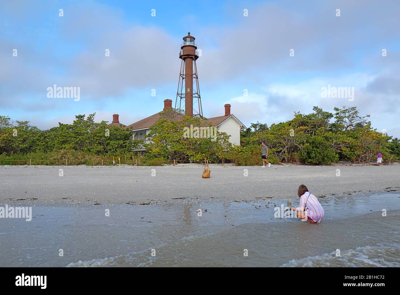 Shellers and beachcombers on Lighthouse Beach by the Sanibel Island or Point Ybel Light on Sanibel Island, Florida Stock Photo