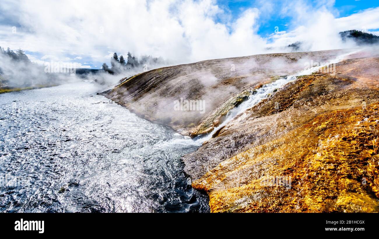 Hot water from the Excelsior Geyser Crater flowing into the Firehole River in Yellowstone National Park, Wyoming, United Sates Stock Photo