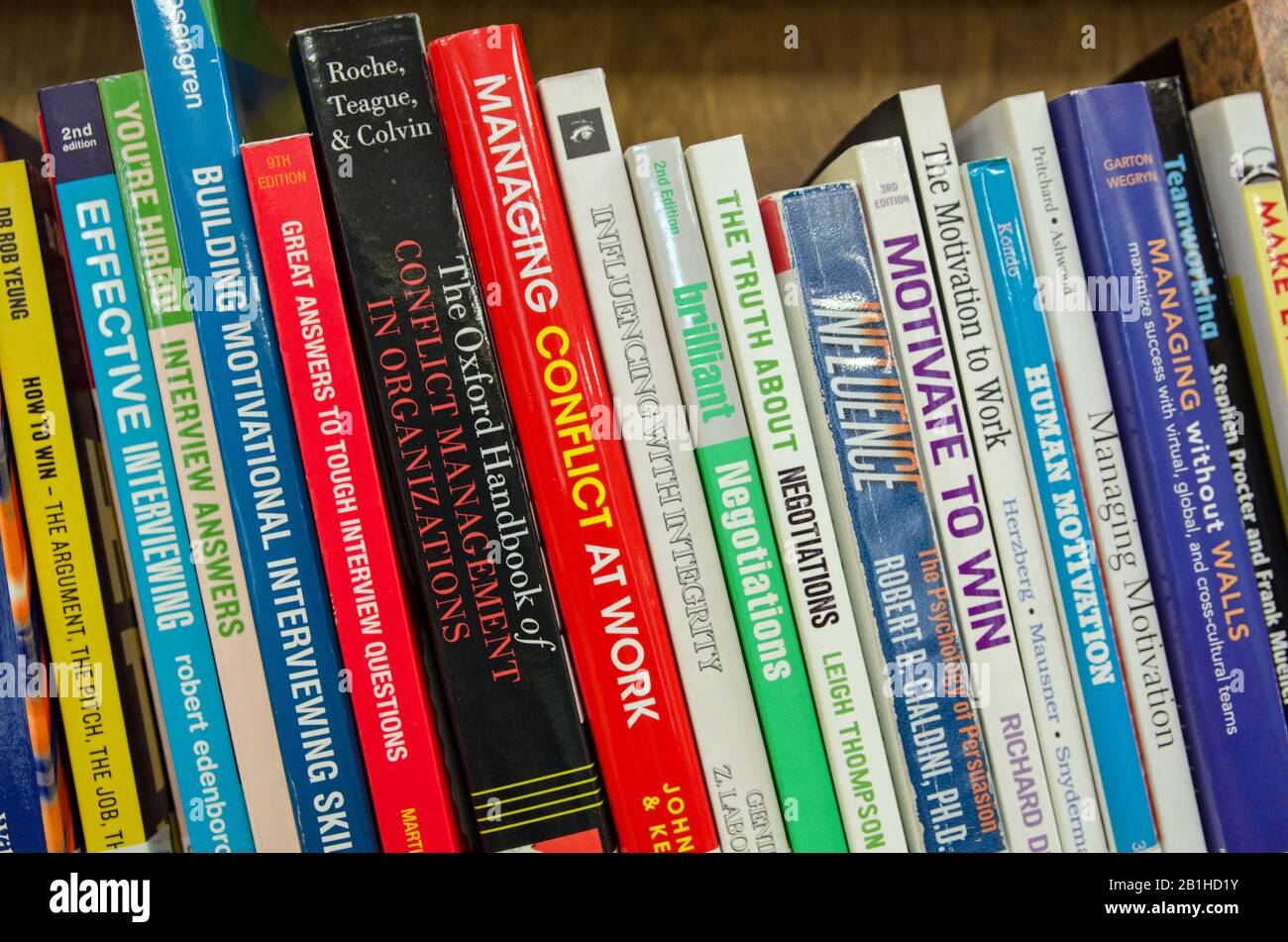 London, UK - September 21, 2019: Management books on display on a library bookshelf. Stock Photo