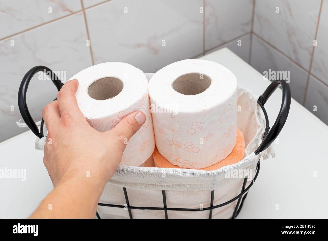 Soft toilet paper rolls in a vintage basket Stock Photo Alamy