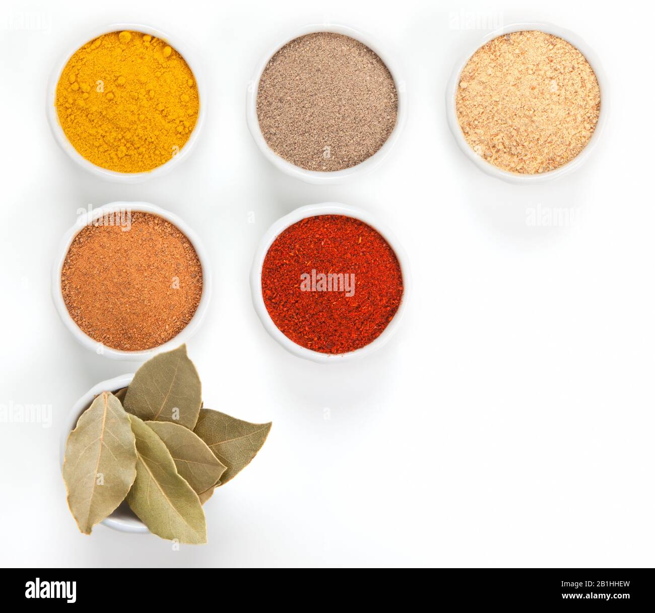 Different spices in white bowls isolated on white background. Paprika