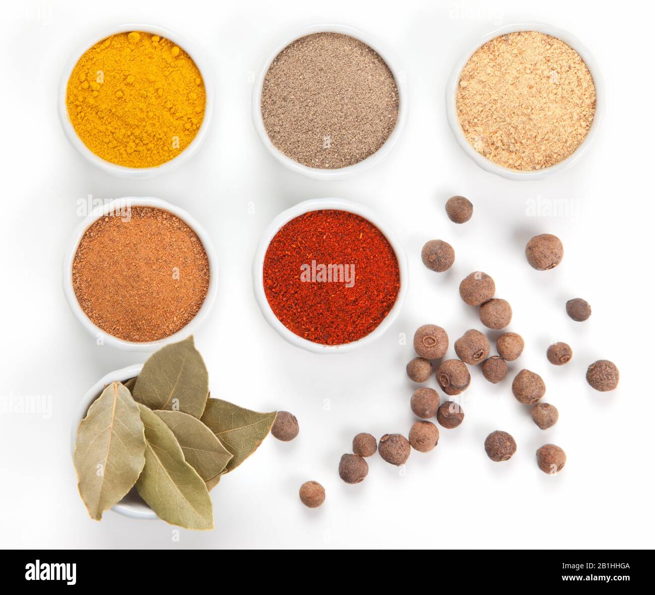 Different spices in white bowls isolated on white background. Paprika