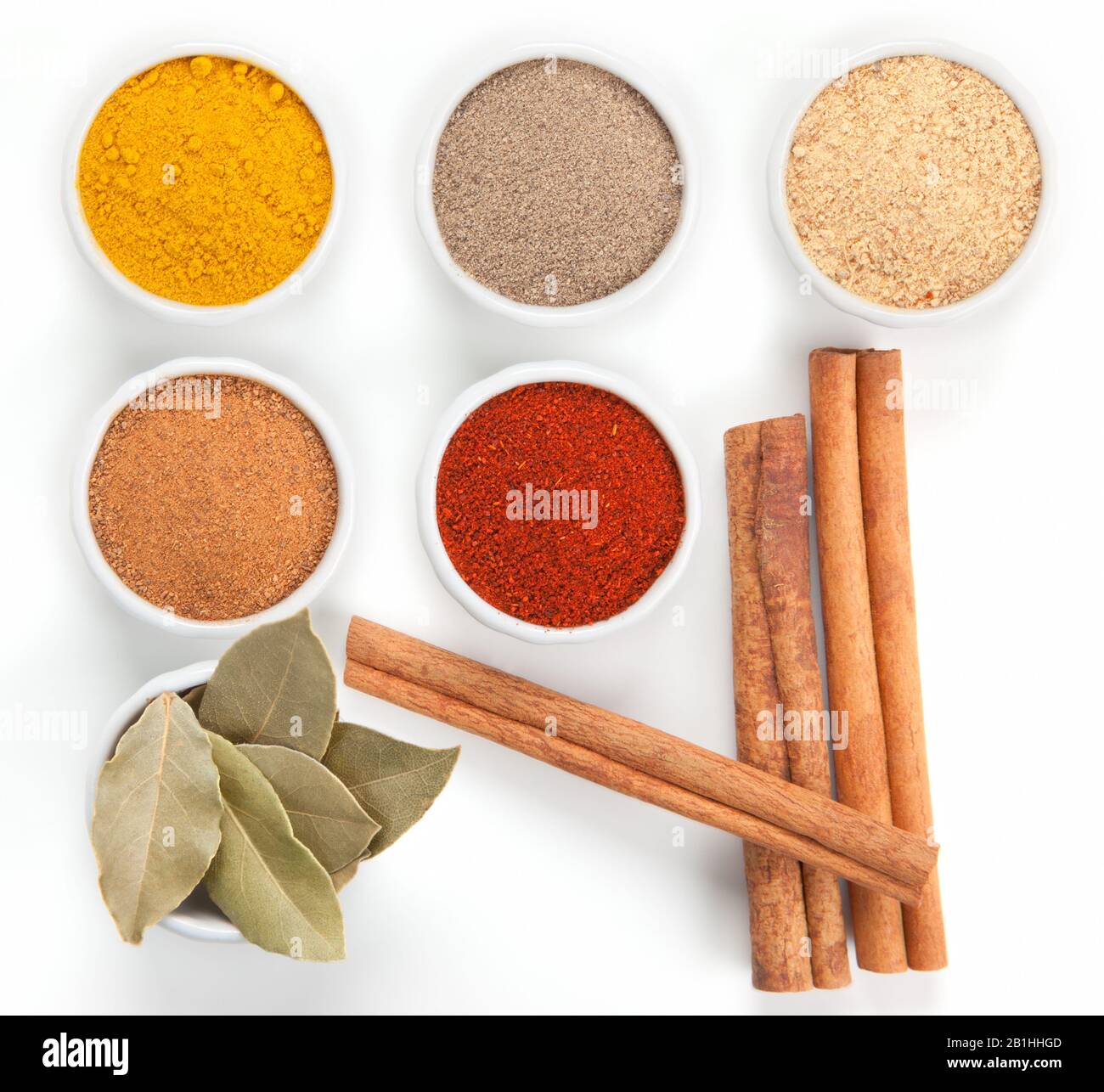 Different spices in white bowls isolated on white background. Paprika