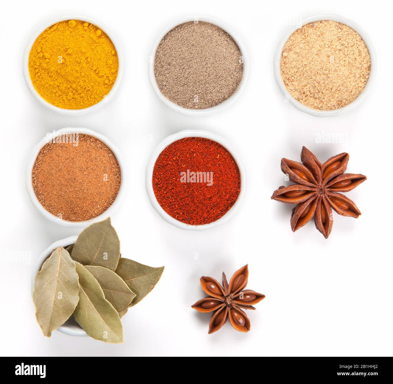 Different spices in white bowls isolated on white background. Paprika