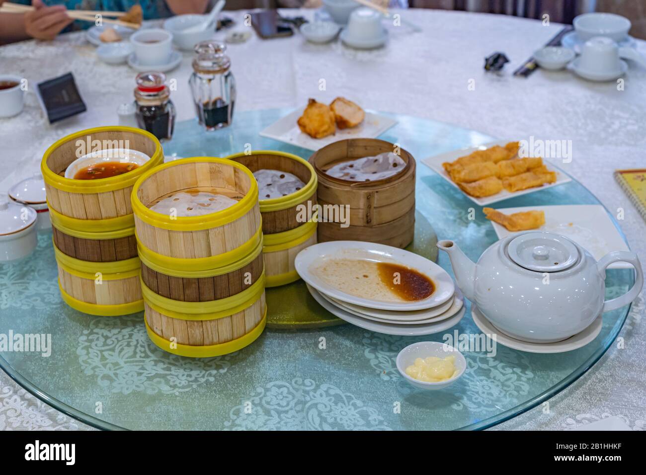 Empty dimsum bamboo steamer boxes and plates on dining table Stock Photo