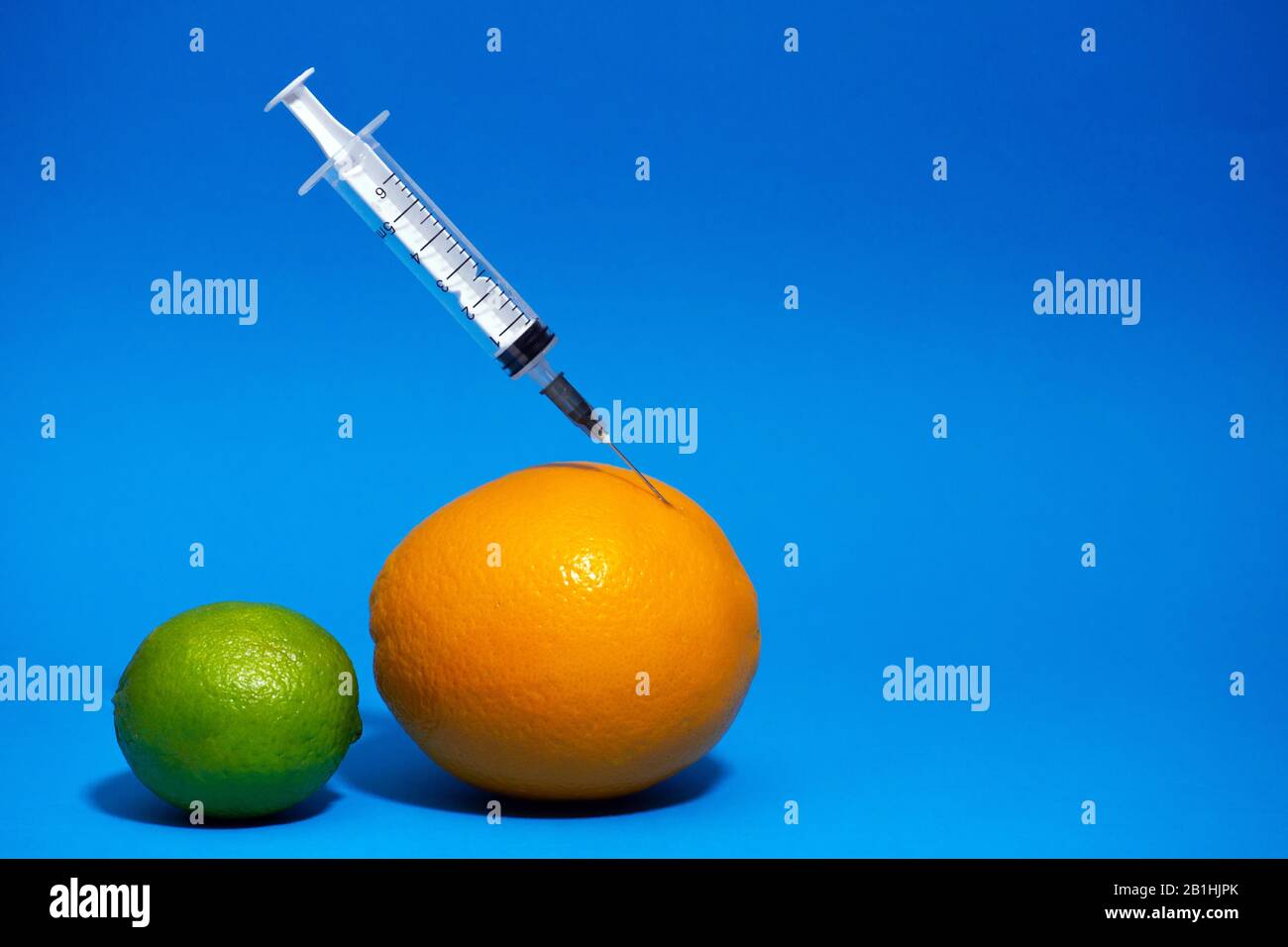 Injection into grapefruit - fruit and syringe chemical GMOfood on a ...