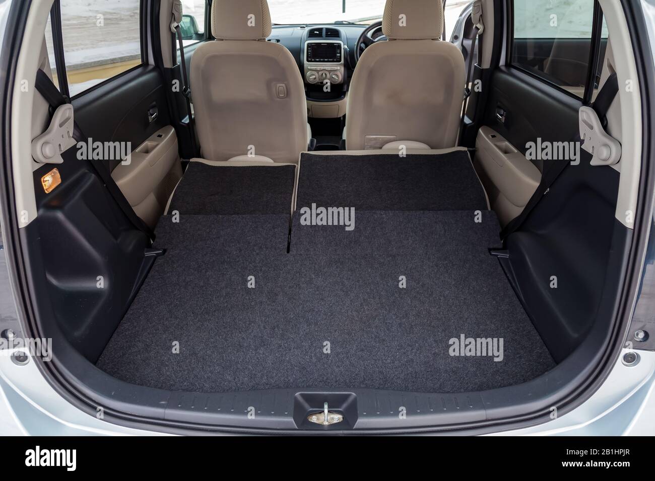 Novosibirsk, Russia - 02.17.2020: View to the beige interior of Toyota Passo with trunk and folded rear seatbacks of hatchback after cleaning before s Stock Photo