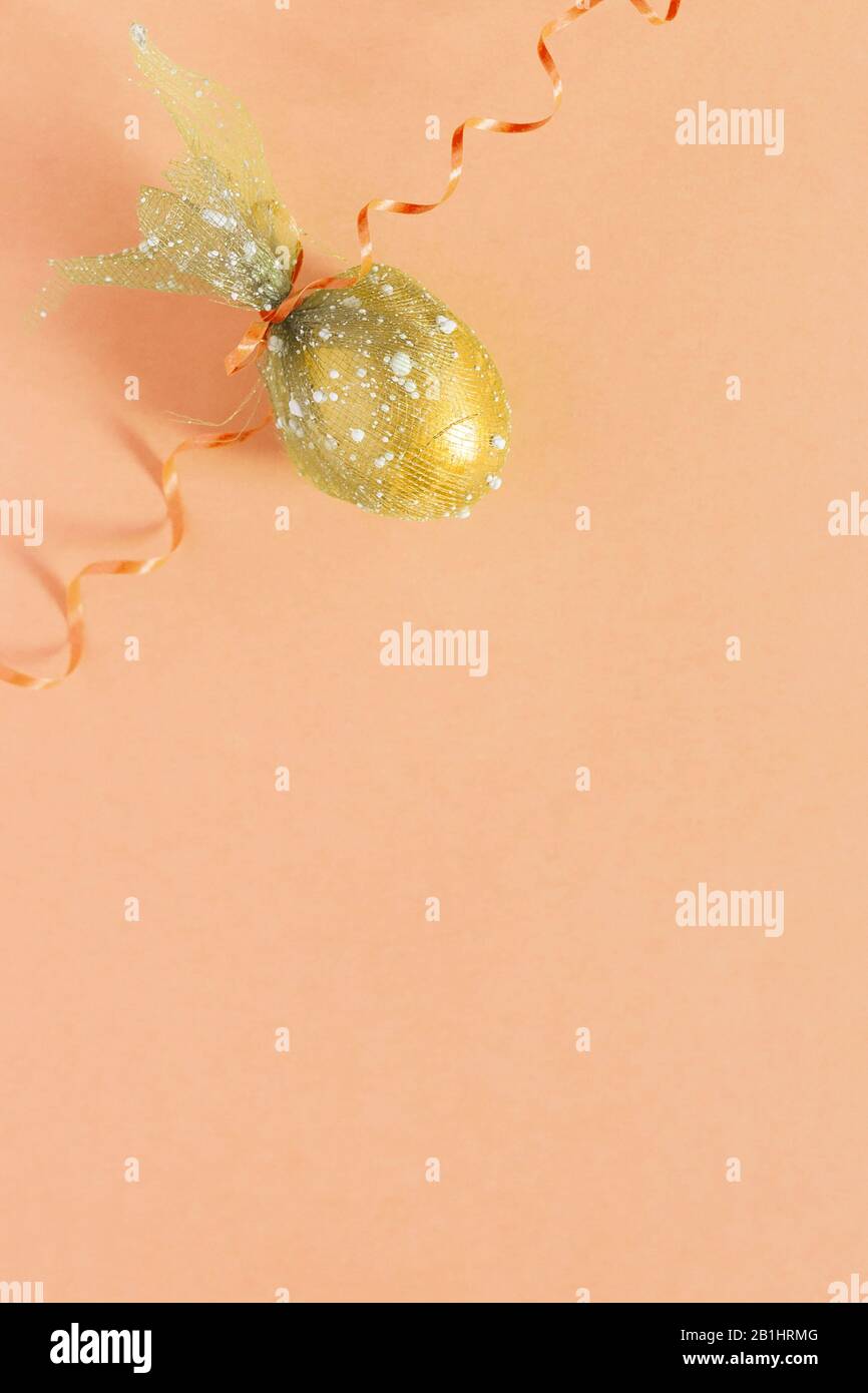 Easter egg and festive ribbon on the colorful background. View from above. Top view. Flat lay image of easter festive holiday background. Concept of Stock Photo