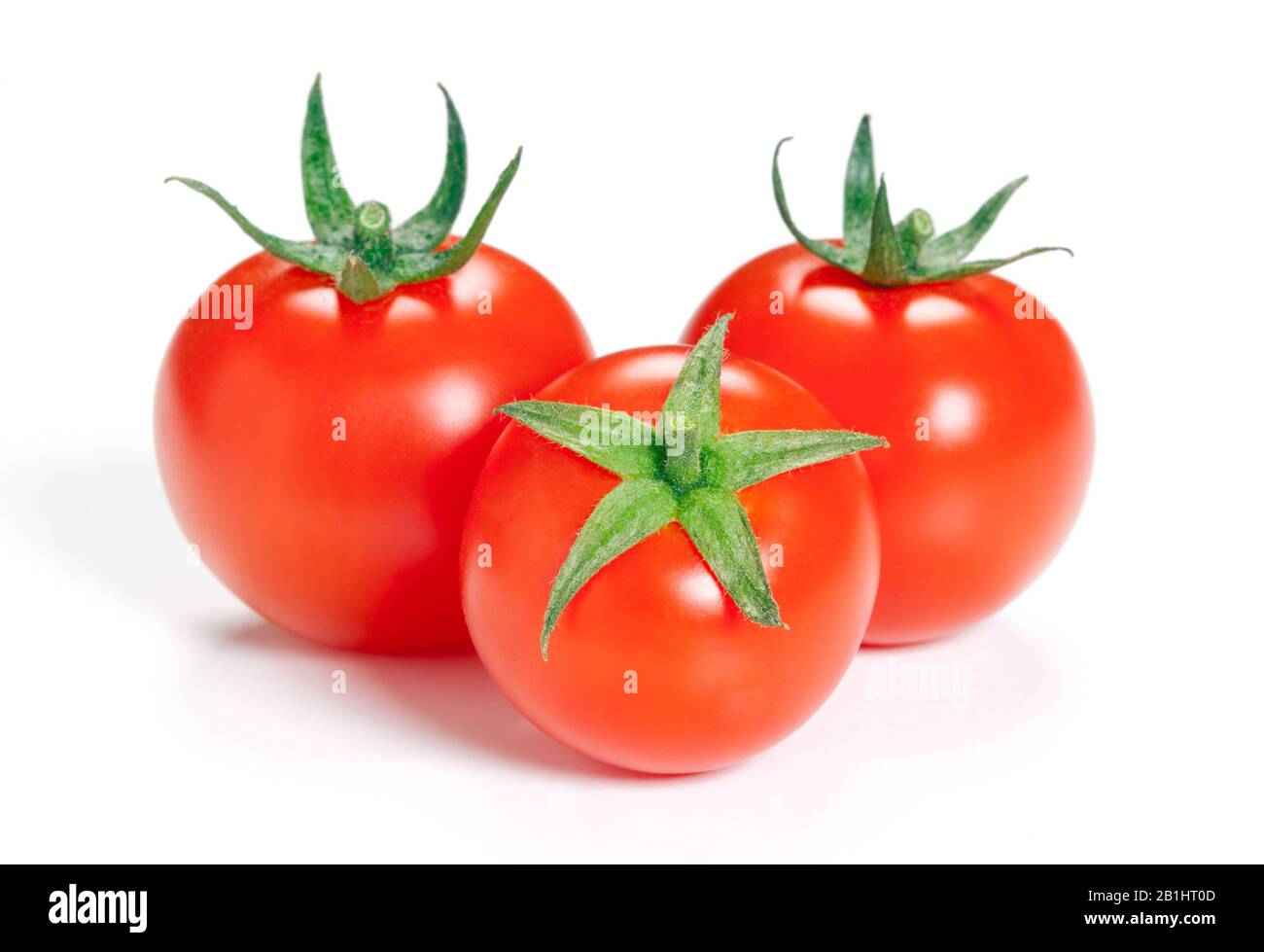 Three ripe tomato isolated on white background Stock Photo - Alamy