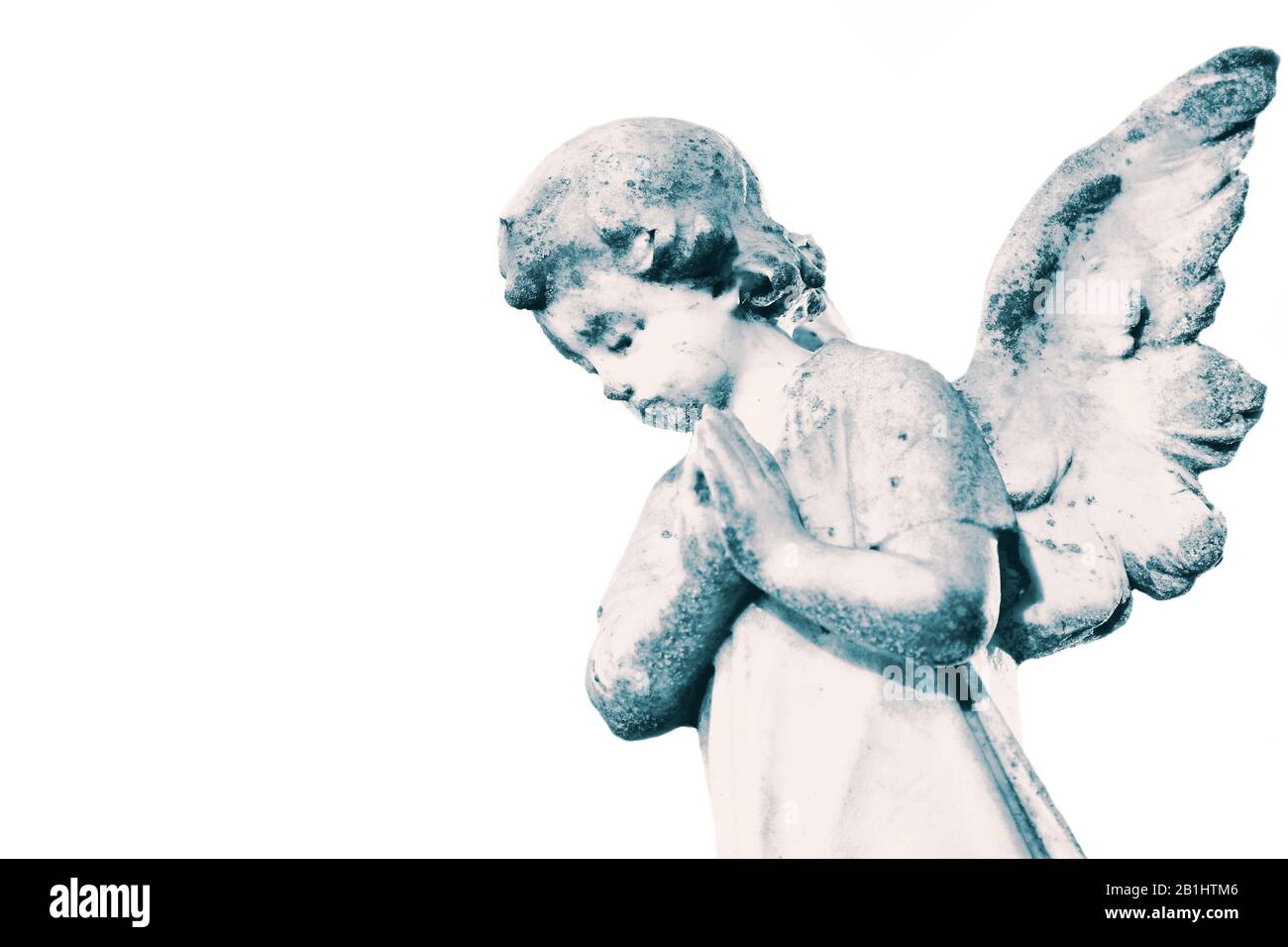 Angel cherub stone statue memorial grave headstone isolated on a white background.  With colour toning Stock Photo