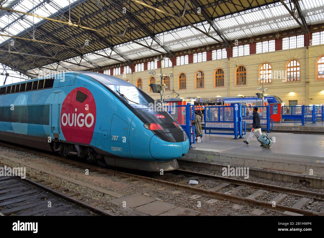 Passengers with SNCF Ouigo high speed trains in the ProvenceAlpesCôte d'Azur livery at