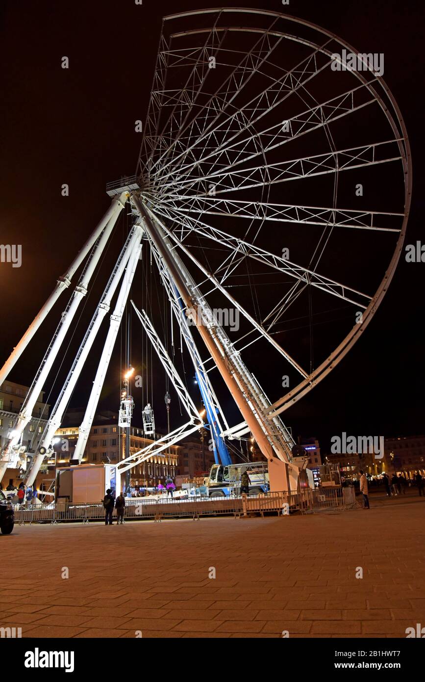 Dismantling the giant ferris wheel in Marseille harbour, France at night. January 2020 Stock Photo