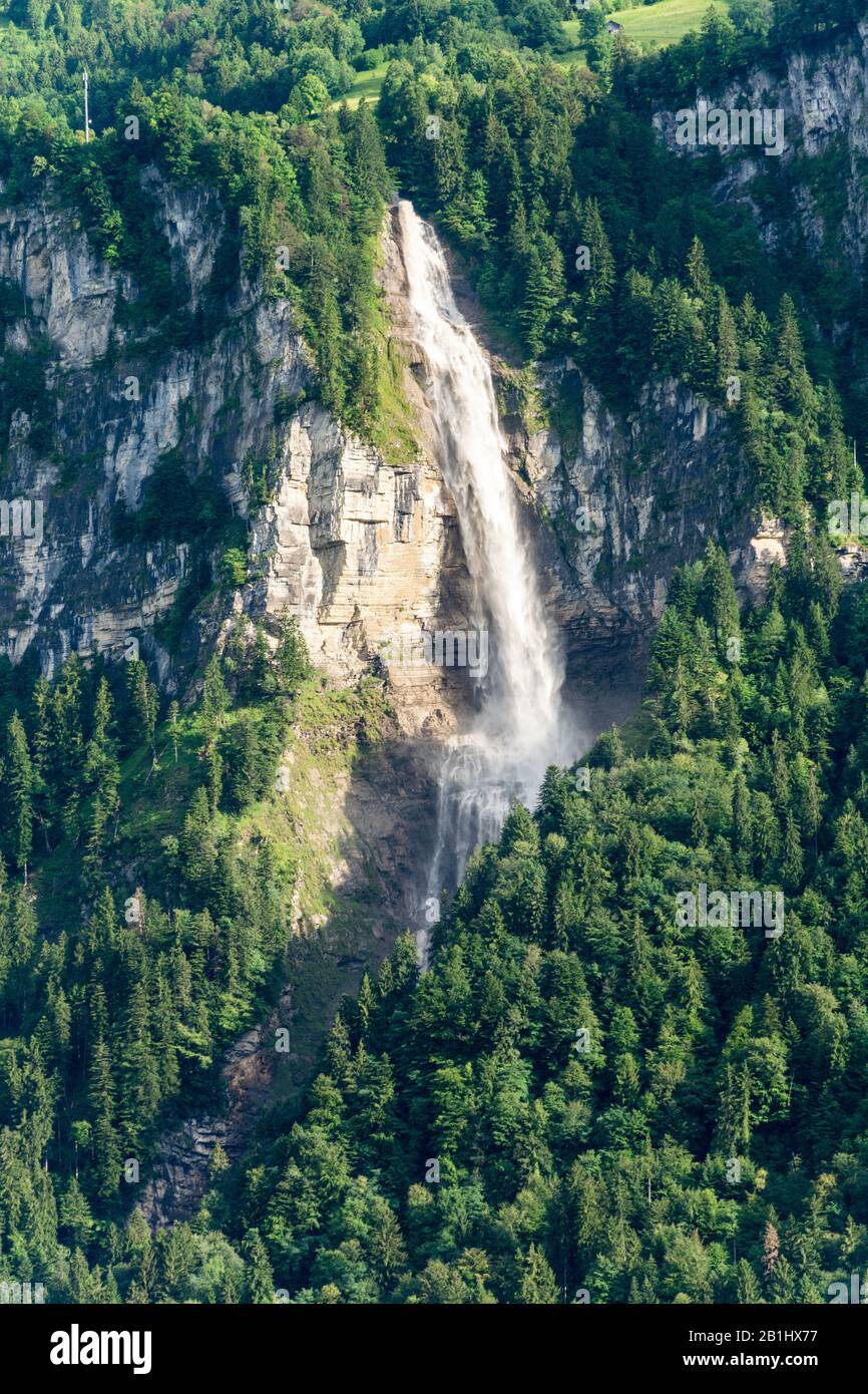 Oltschibachfall waterfall near Meiringer in Switzerland. The water of the river Oltschibach plunges down over 300 meters. The upper part is a vertical Stock Photo