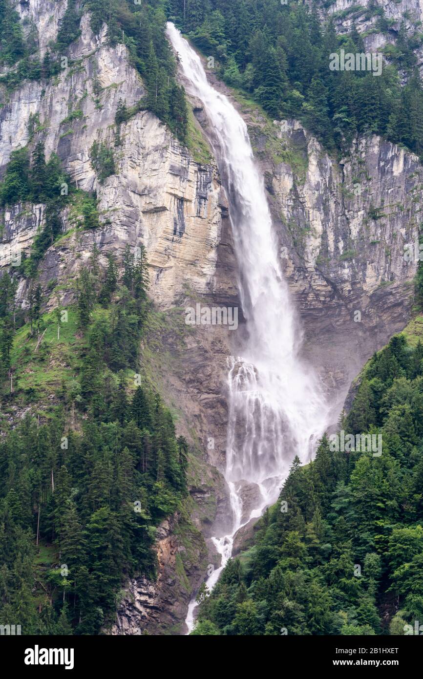 Oltschibachfall waterfall near Meiringer in Switzerland. The water of the river Oltschibach plunges down over 300 meters. The upper part is a vertical Stock Photo