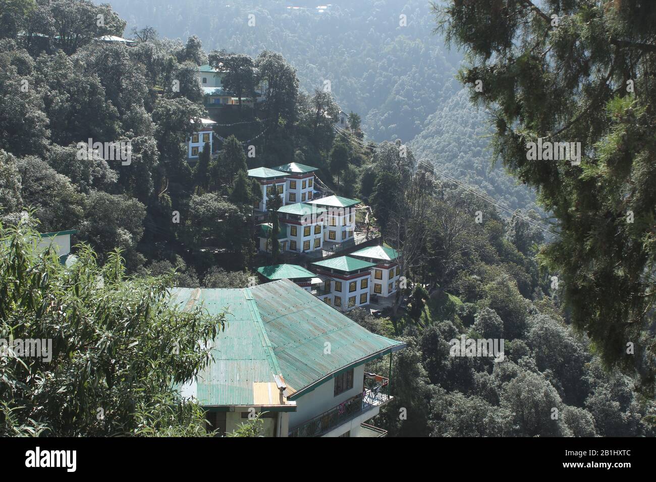 View of Hotel Omkar  and dense forest from Shedup Choephelling Buddhist Temple, Mussoorie, Uttarakhand, India Stock Photo
