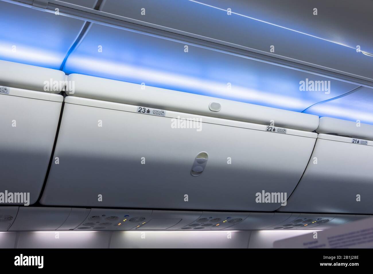 Closed luggage racks for hand luggage in an airplane Stock Photo