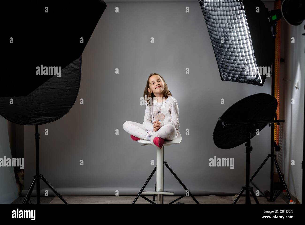 Photographing children in professional photo studio with lighting