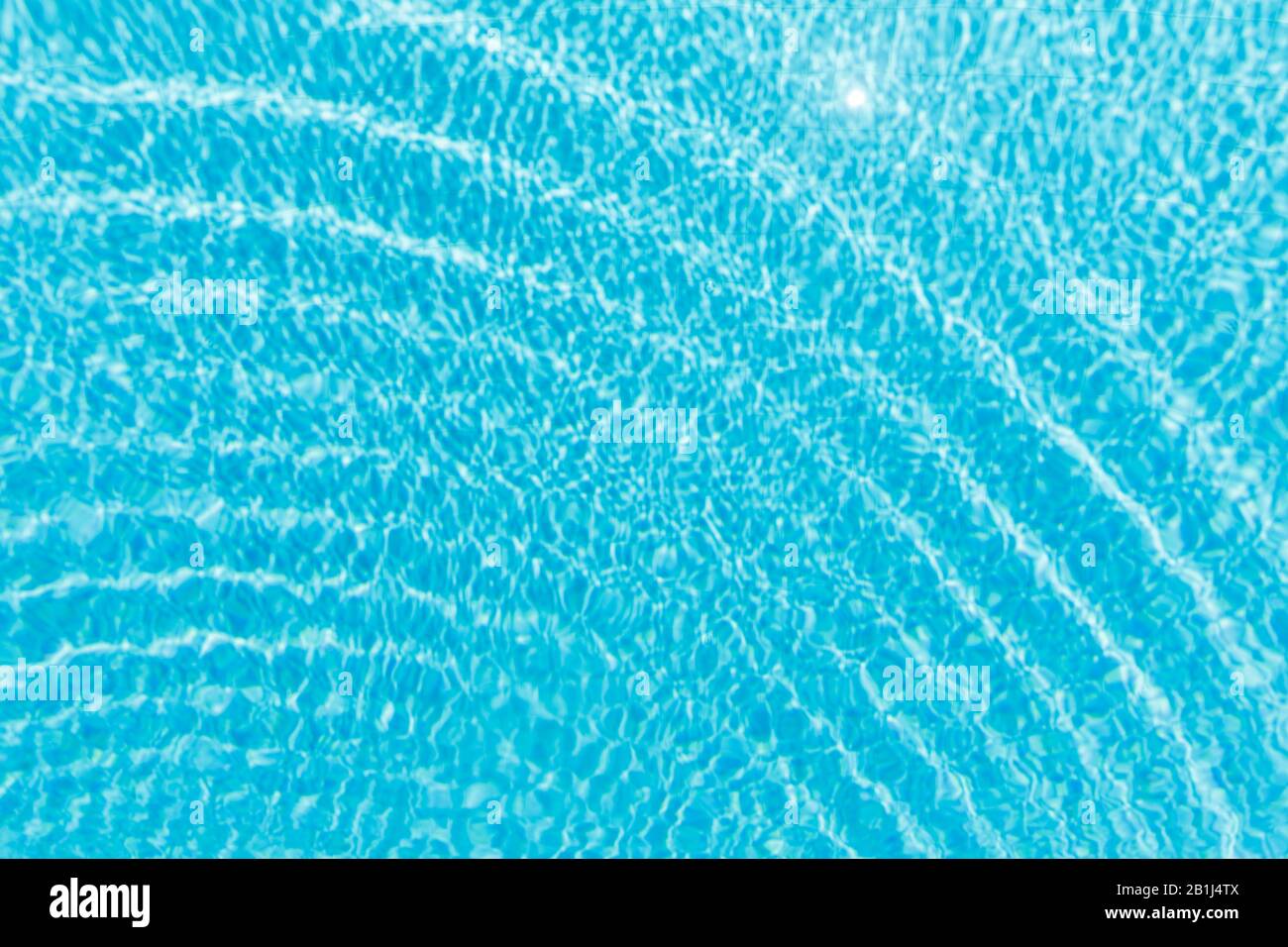 Surface of blue shining swimming pool water ripple and sun reflection ...