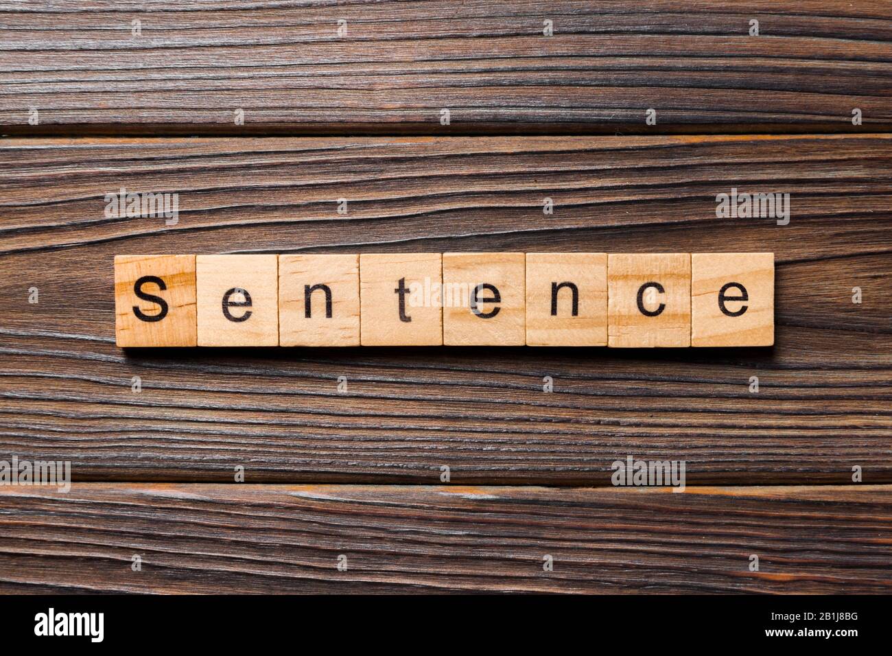 Sentence word written on wood block. Sentence text on table, concept