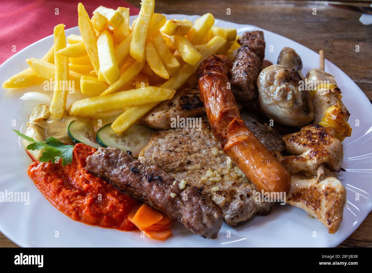 Mixed grill platter with grilled meat and sausages in Slovenia. Stock Photo