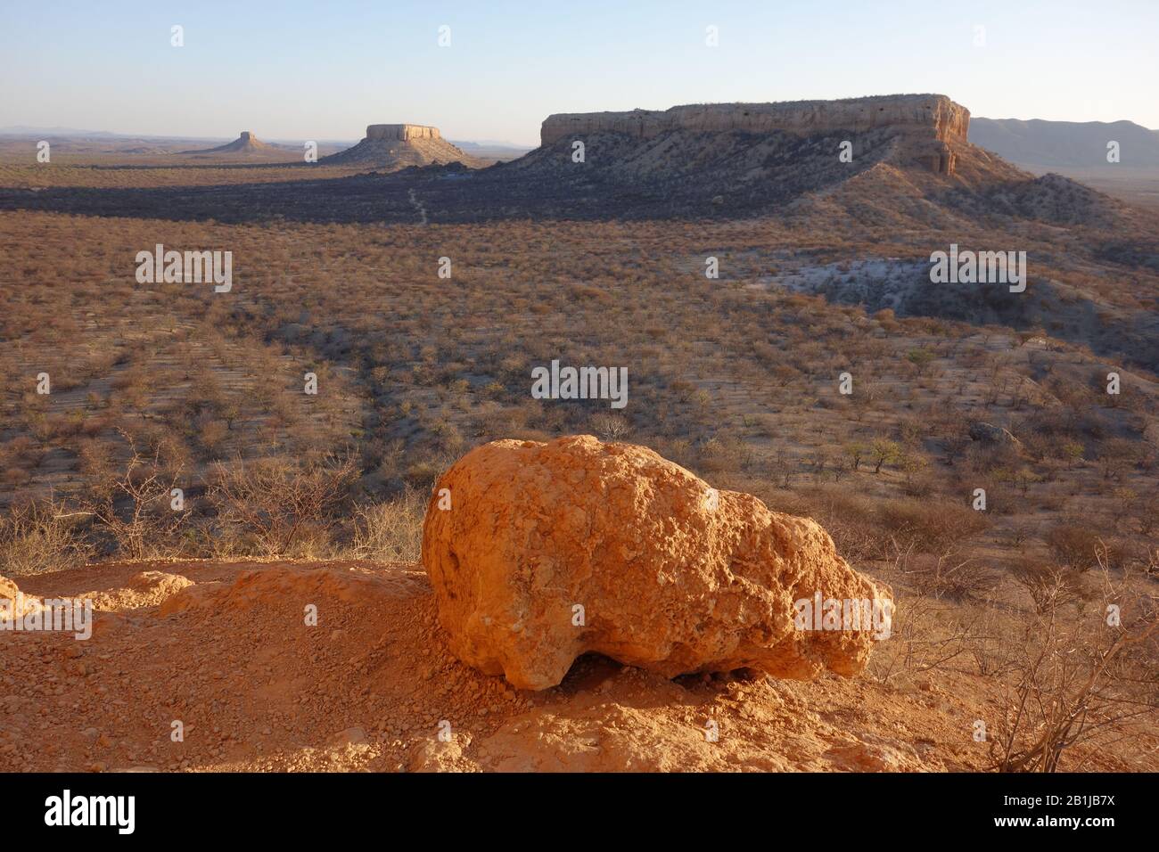 Ugab-Terrace called Vingerclip during sunset in Namibia , close to Ugabe Terrace Lodge . Flat and plain country with plateau and big red stone rock Stock Photo
