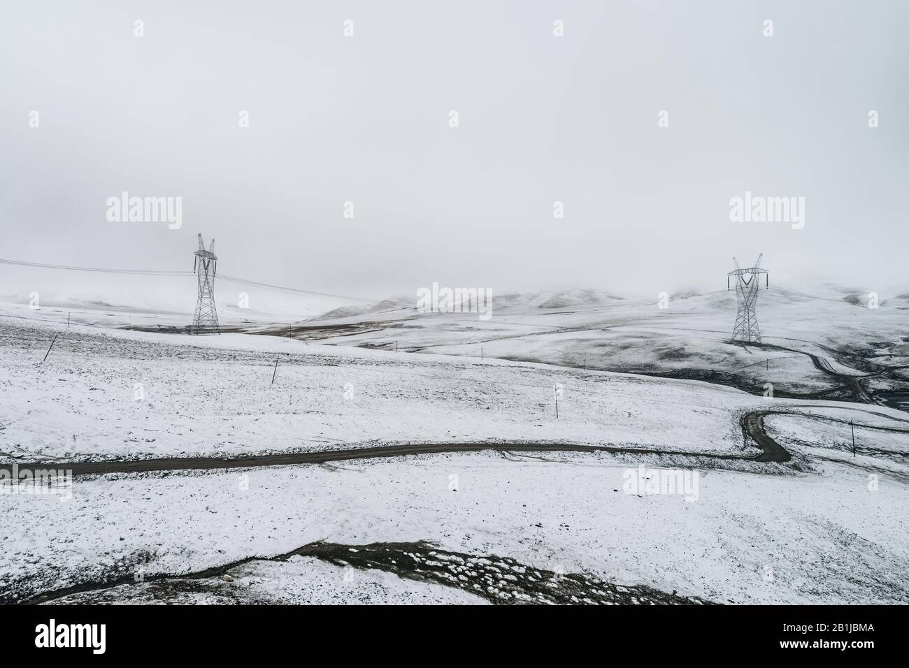 electricity pylon on the mountain which covered with snow Stock Photo ...