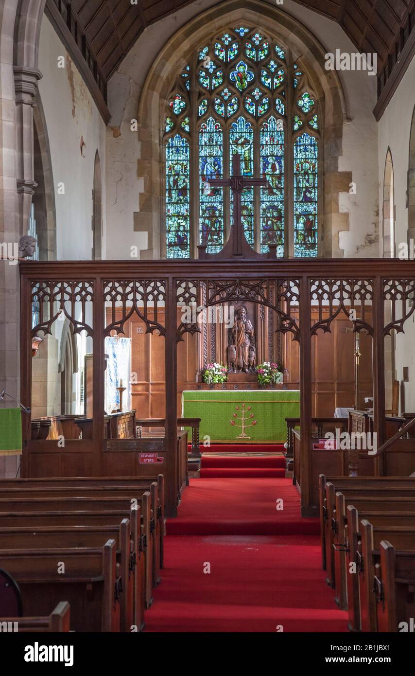 The altar, stained glass windows and benches at St Marys church in ...