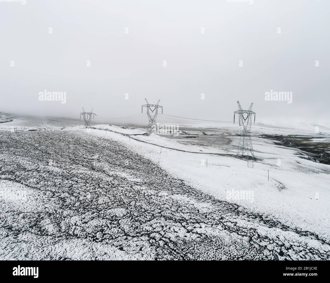 electricity pylon on the mountain which covered with snow Stock Photo ...