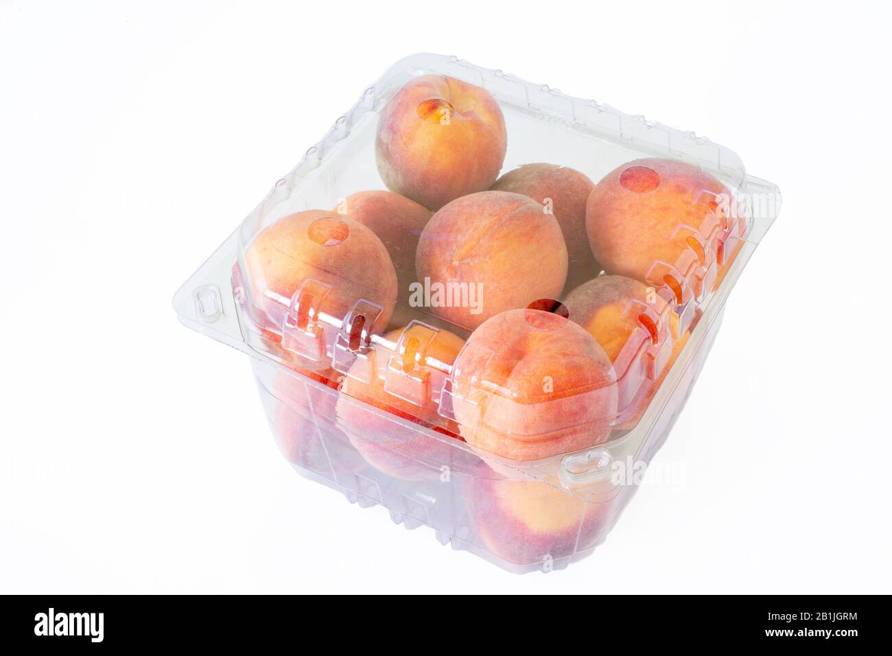 Peaches for sale in clear plastic cellophane boxes. Stock Photo