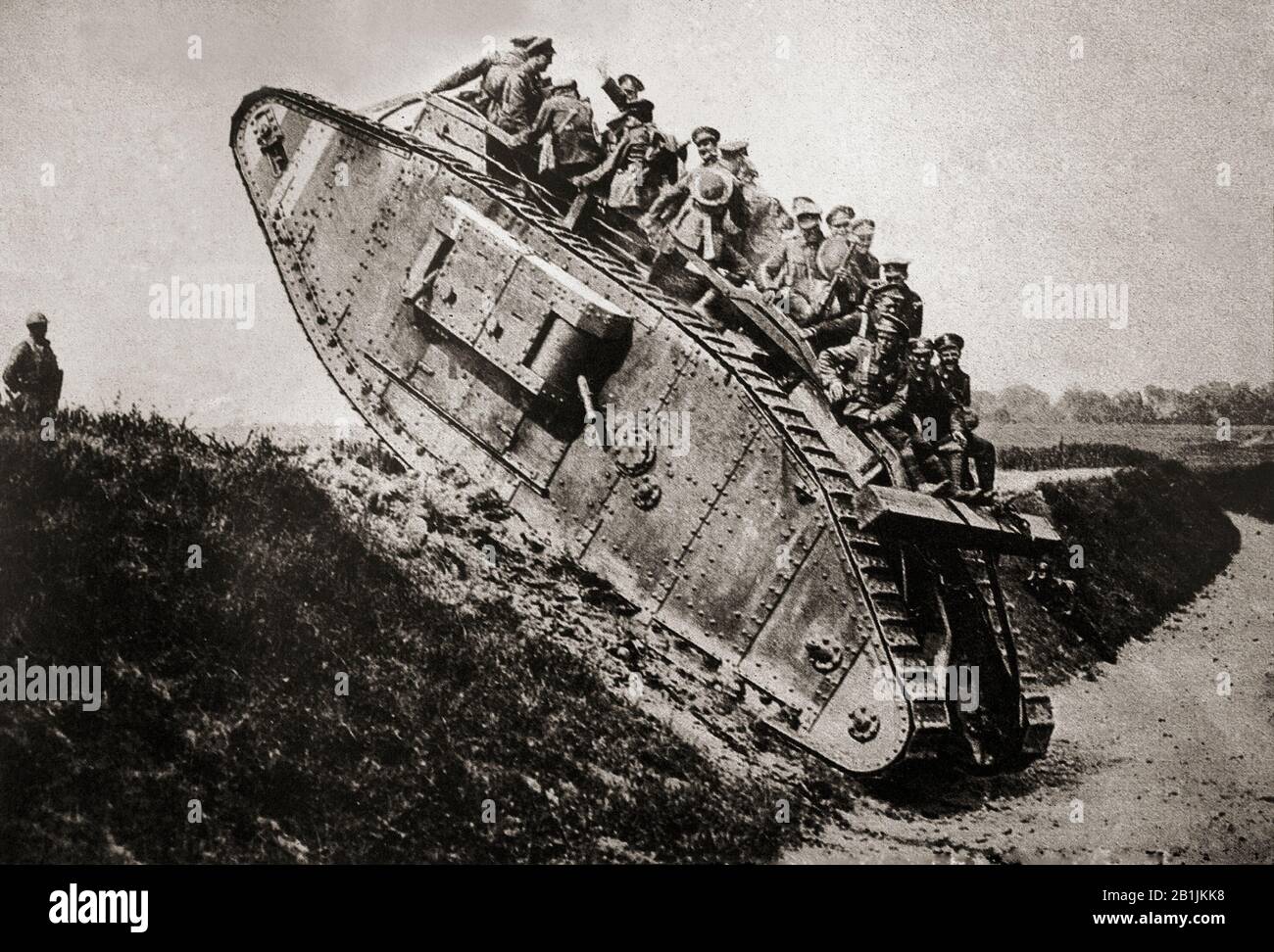 A British Mark IV (female) tank giving a lift to artillerymen during World War One. Stock Photo
