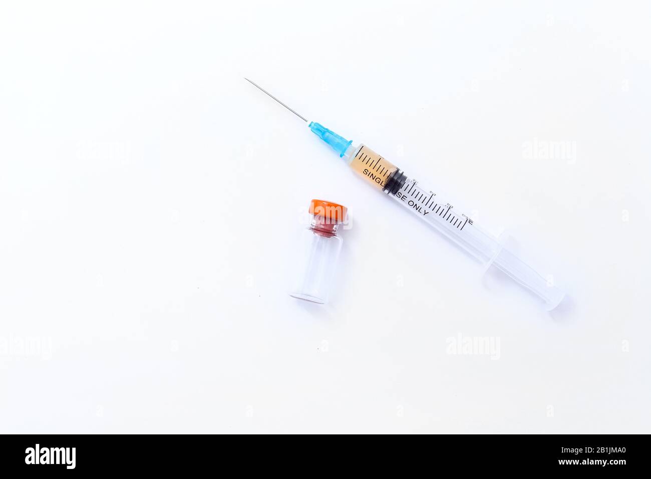 Disposable syringe and vial of medicine on a white background. Vaccination session,flu season med concept. Stock Photo