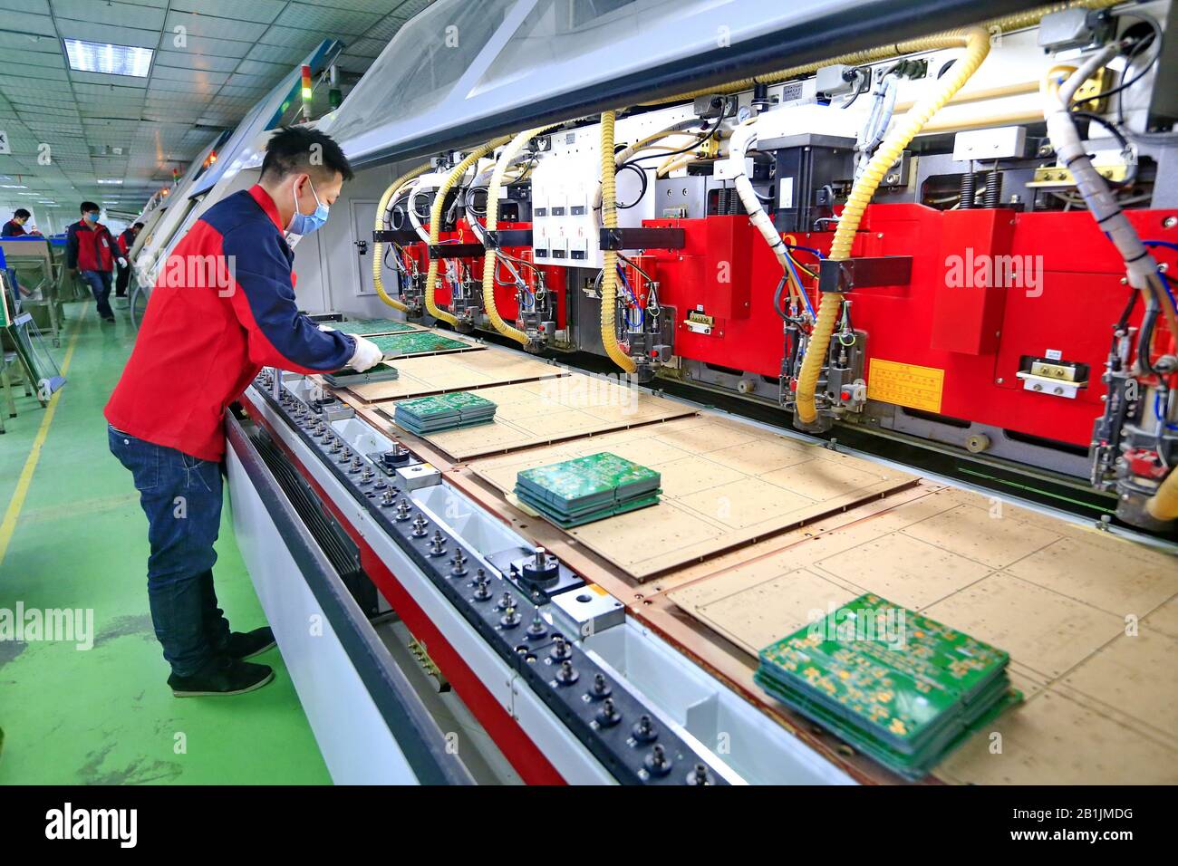 Chinese workers manufacture printed circuit boards (PCB) which are used