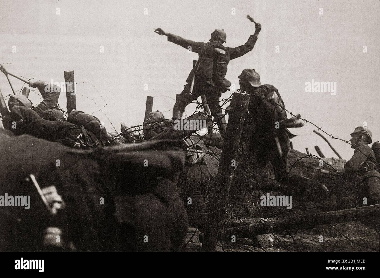 A French soldier throwing a hand grenade towards German lines during the Battle of Verdun of 1916. The battle lasted for 302 days, the longest and one of the most costly in human history during which the French suffered 377,231 casualties and the Germans 337,000, a total of 714,231. In France, the battle came to symbolise the determination of the French Army and the destructiveness of the war. Stock Photo