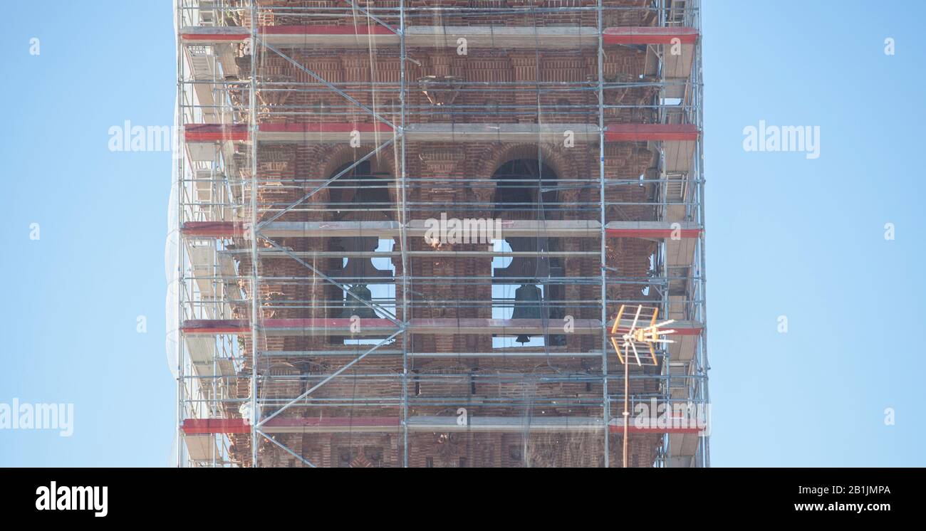 Church Tower covered with scaffoldings. Heritage preservation concept Stock Photo