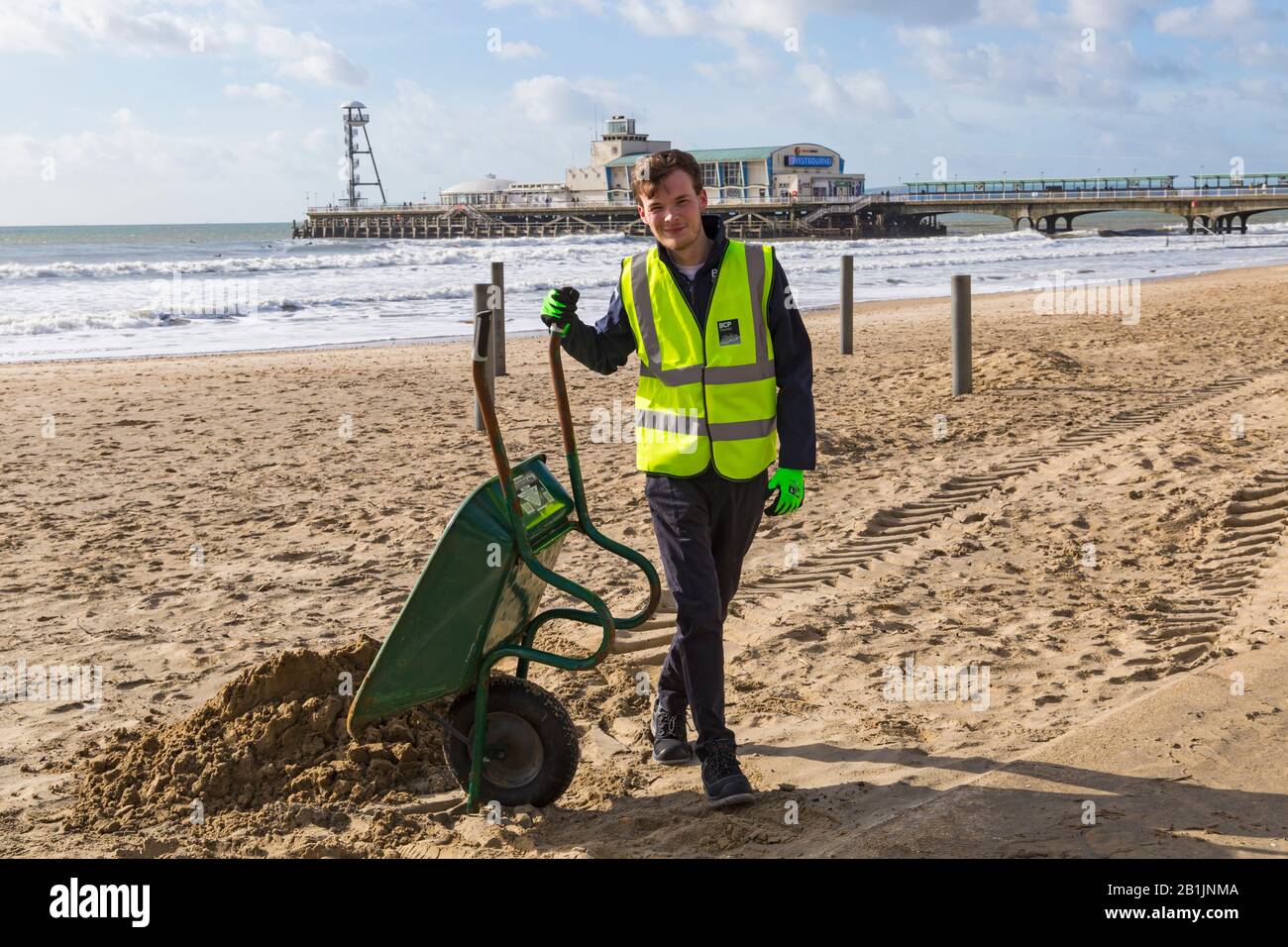 Bournemouth, Dorset, UK. 26th Feb 2020. Councillor Lewis Allison, gets stuck in and gives the seafront rangers a hand to clear the sand from the promenade, blown up from the recent strong winds and Storm Dennis.   Councillor Allison is Labour Councillor for Boscombe West and Portfolio Holder, Cabinet Member, for Tourism, Leisure and Communities at BCP (Bournemouth, Christchurch and Poole) Council.  Credit: Carolyn Jenkins/Alamy Live News Stock Photo