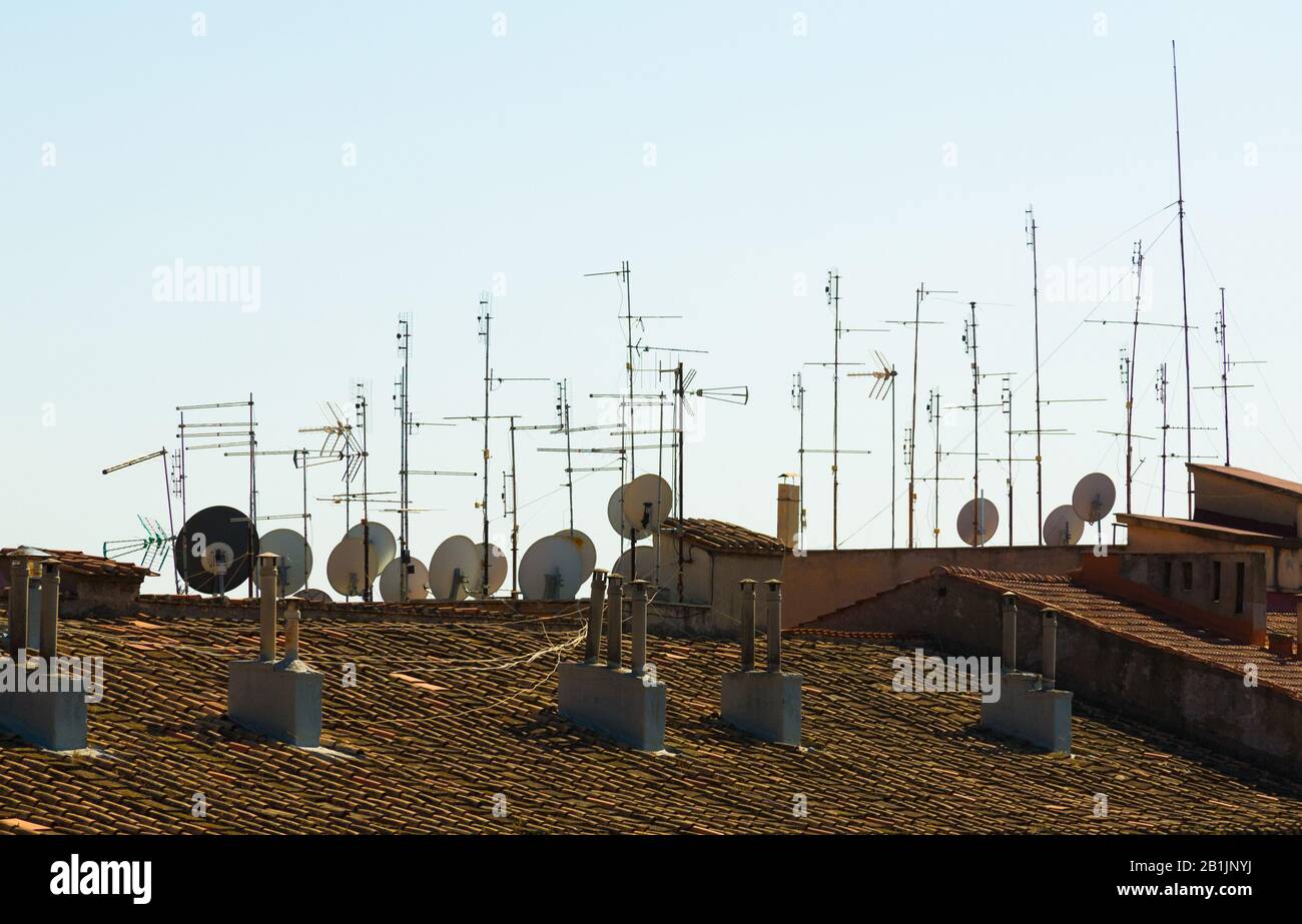 television reception antennas and satellite dishes on rooftop Stock Photo